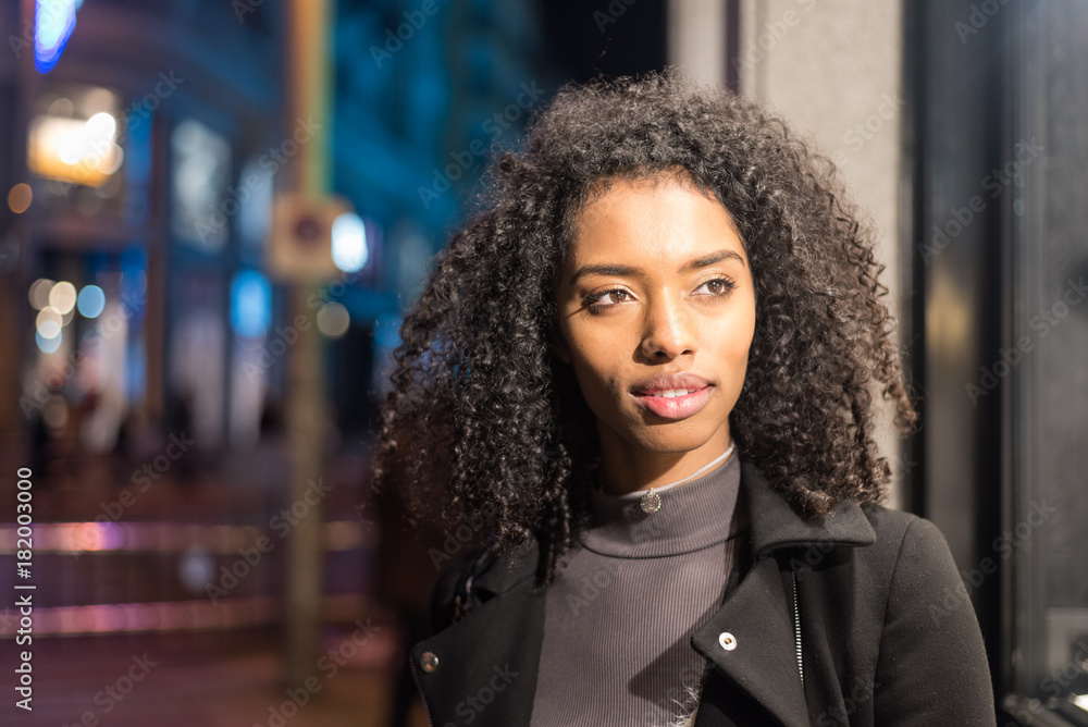 Fototapeta premium woman wondering in the city by night