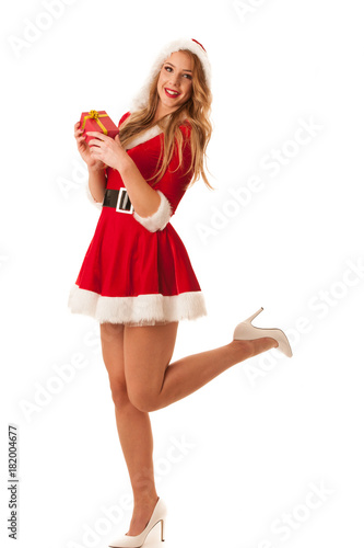 Full length portrait of a woman in santa calus dress holding a present isolated over white background