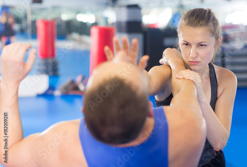 Nice woman is fighting with trainer