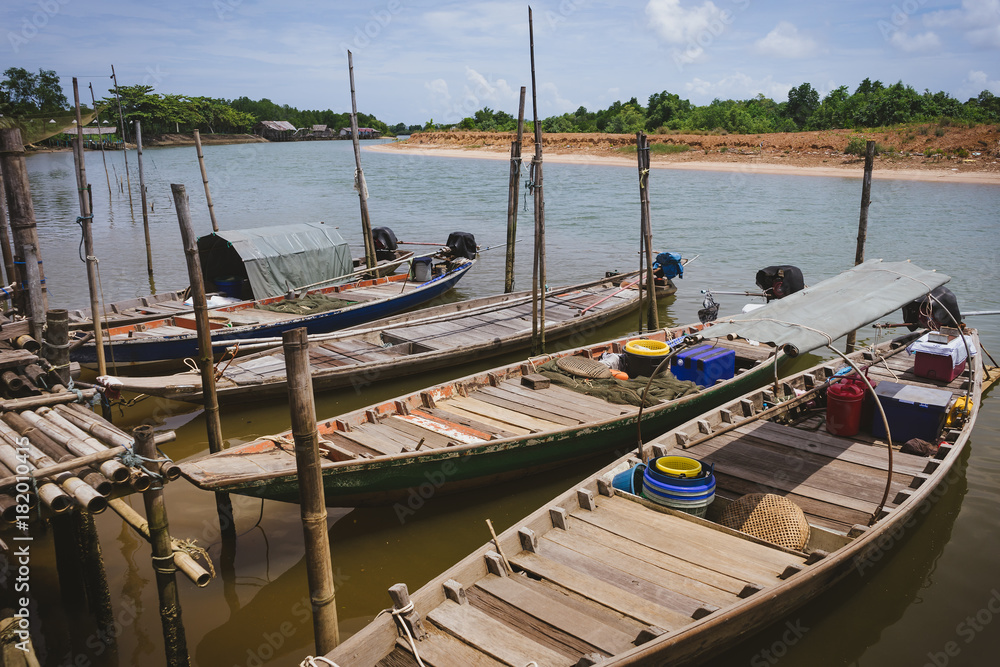 Small fishing boats parked near the river.