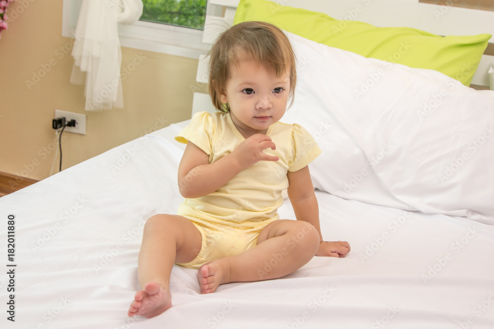 Cute baby on a soft bed in the house. Cute baby on a soft bed in the house.