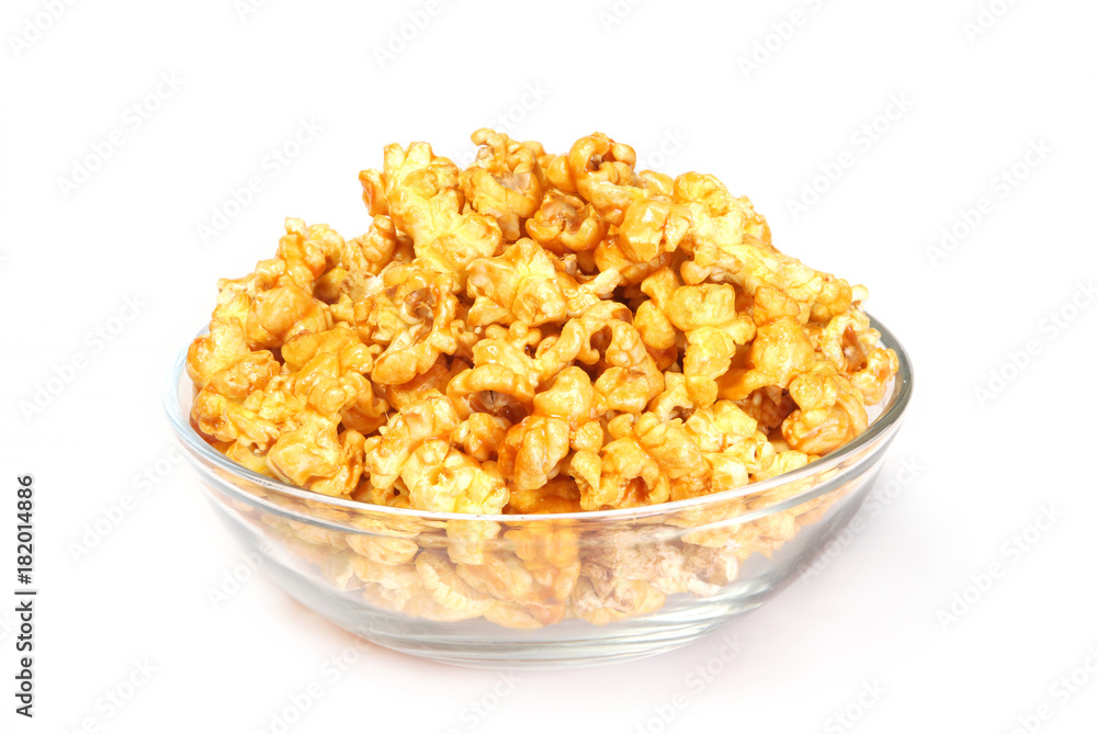 A bowl of sweet caramel popcorn isolated on white A bowl of sweet caramel popcorn isolated on white