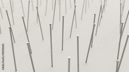 Uniformly packed grid of iron nails under neutral studio lighting.