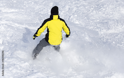 Man is snowboarding in the snow in winter