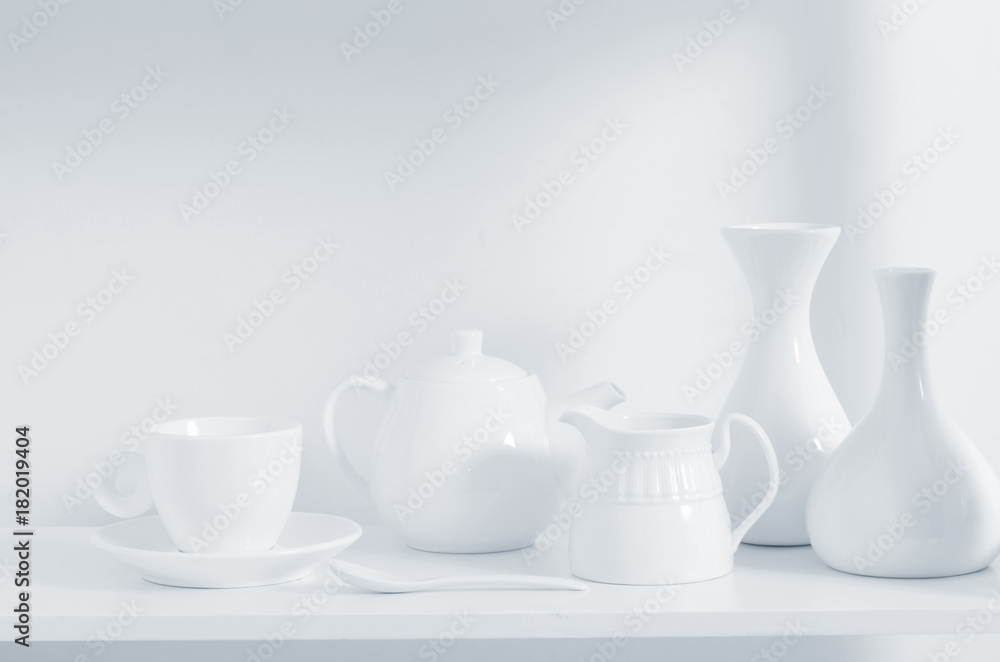 white dishvare on wooden shelf white dishvare on wooden shelf