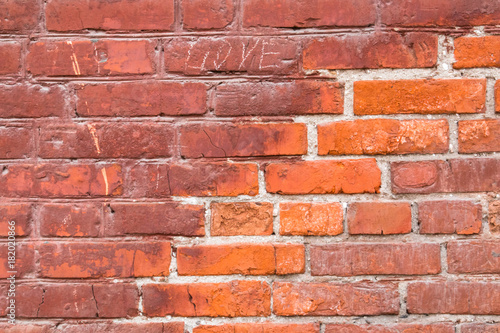 Old wall of red and orange silicate bricks background