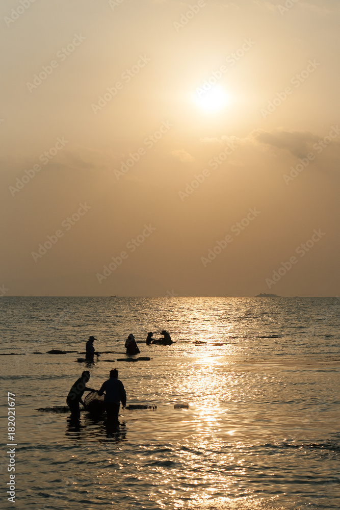 Fisherman working in morning sun at Cambodian coast