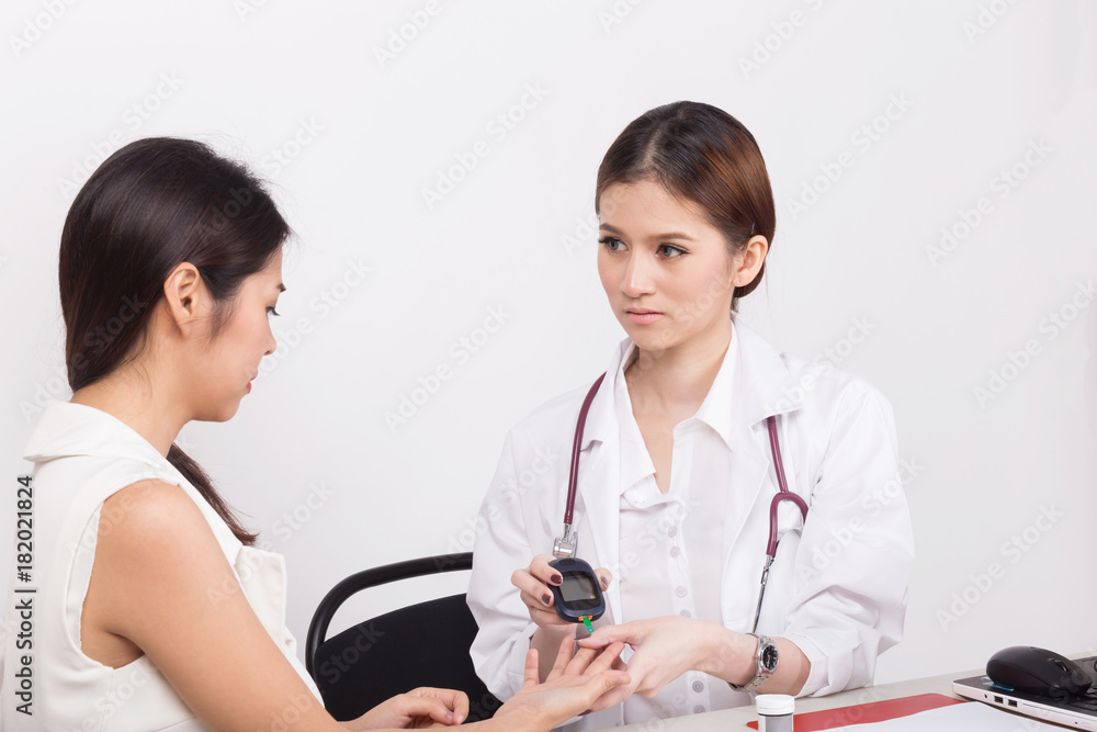Young doctor checking the blood-sugar level in the hospital room. Young doctor checking the blood-sugar level in the hospital room.