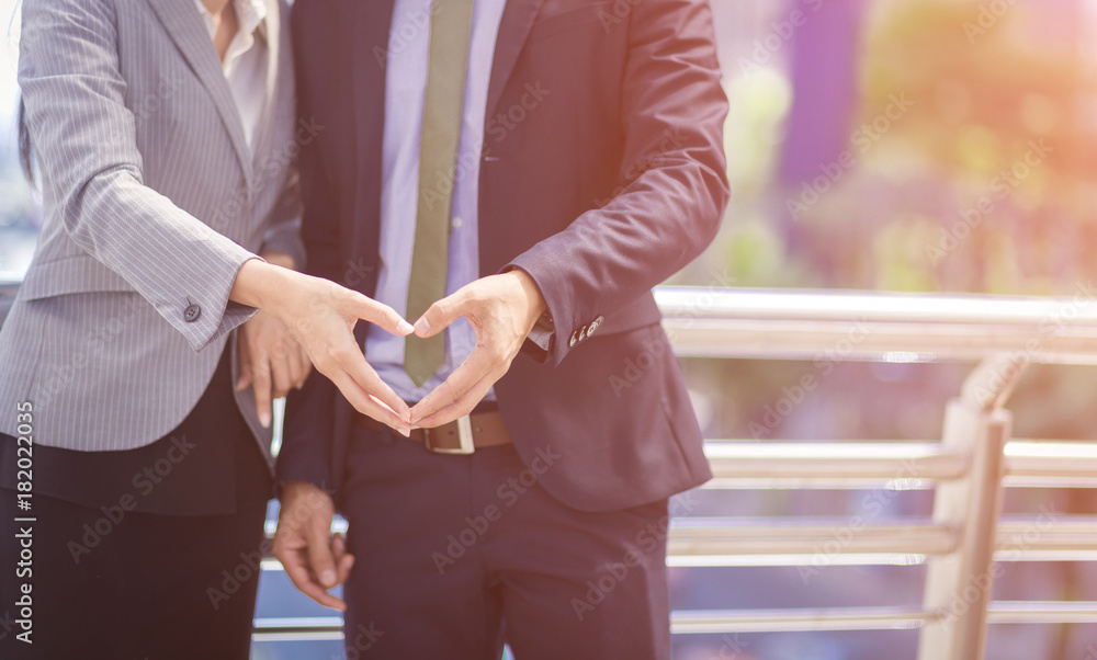 Hand of Businessman and Businesswoman in heart shape,feeling love in office Hand of Businessman and Businesswoman in heart shape,feeling love in office