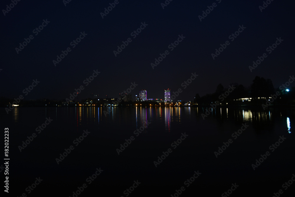 The view from the park Herastrau of the lake, at night, in Bucharest, Romania .