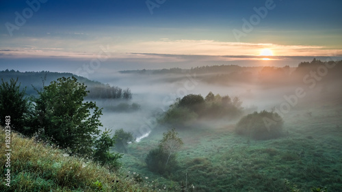 Wonderful dawn at foggy valley in autumn, Europe