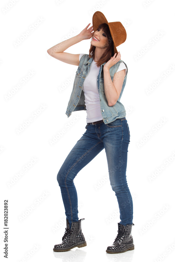 Beautiful Young Woman In Brown Hat Is Smiling And Looking Away Beautiful Young Woman In Brown Hat Is Smiling And Looking Away