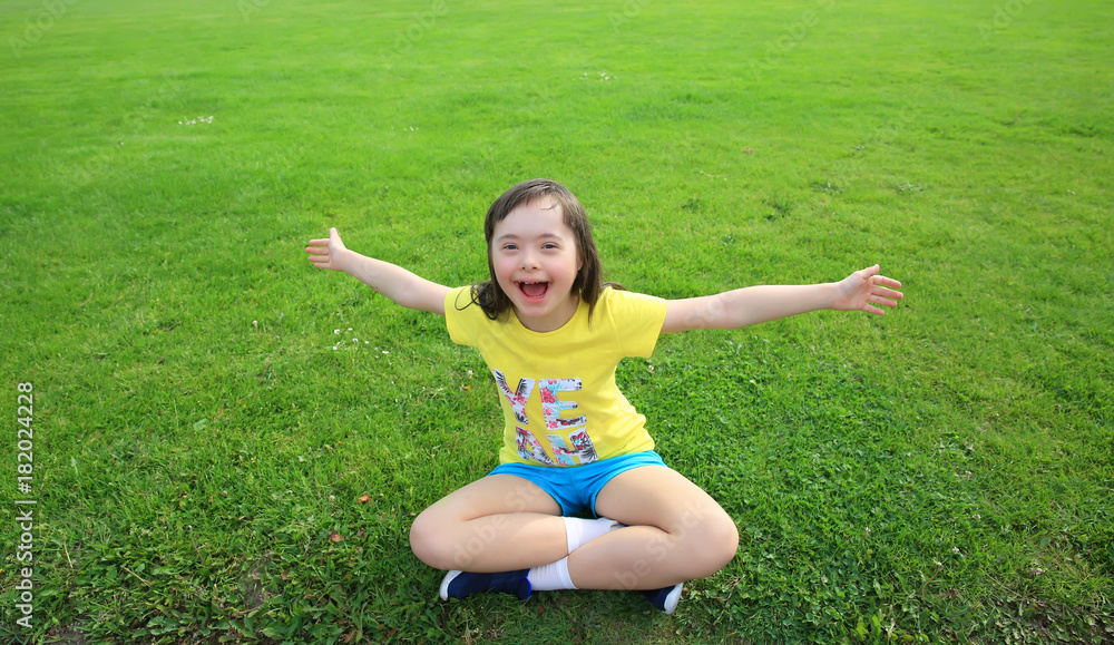 Young girl on the background of green grass Young girl on the background of green grass