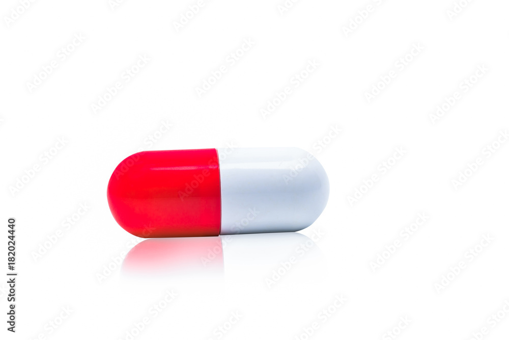 Red, white capsule pills isolated on white background with shadow and copy space for text. Drug resistance concept. Antibiotics drug use with reasonable and global healthcare concept. Red, white capsule pills isolated on white background with shadow and copy space for text. Drug resistance concept. Antibiotics drug use with reasonable and global healthcare concept.