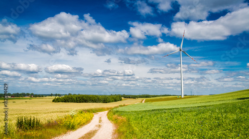 Wind turbines on green field as alternative energy in summer