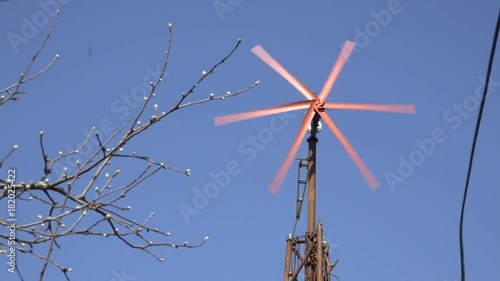 Wind Turbine Start Rotation, Green Energy on Blue. 4K UltraHD video.