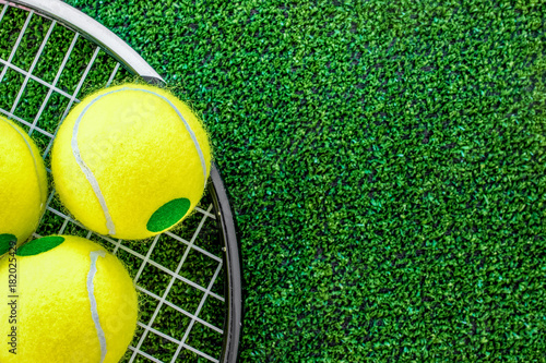 tennis racket on green background top view