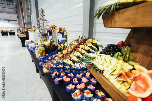 Rich served dishes with different fruits and stand on the table