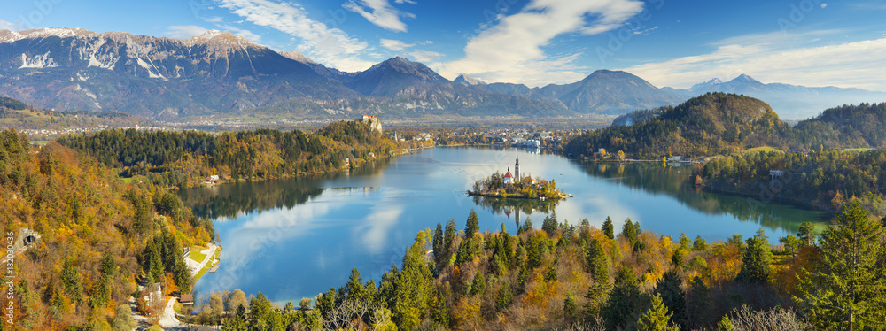 Obraz premium aerial view to lake with island under clouds in Slovenia