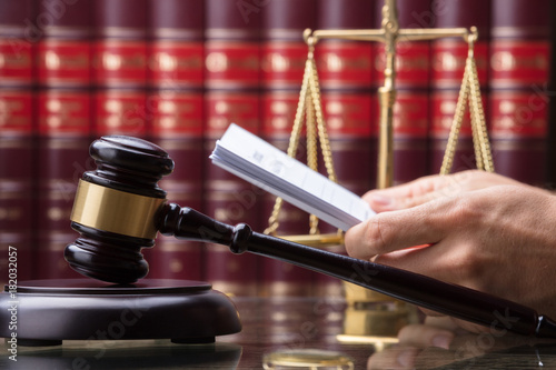 Wallpaper Mural Gavel In Front Of Person Holding Document Torontodigital.ca