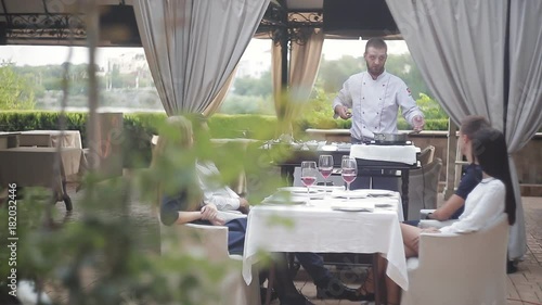 Show kitschen at the summer site of a meat restaurant. Preparation of foie gras before the company of guests. photo