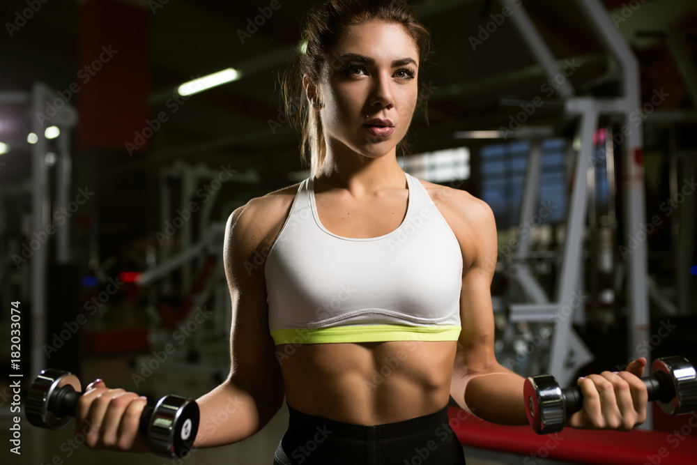 Fototapeta premium A girl trains in the gym.