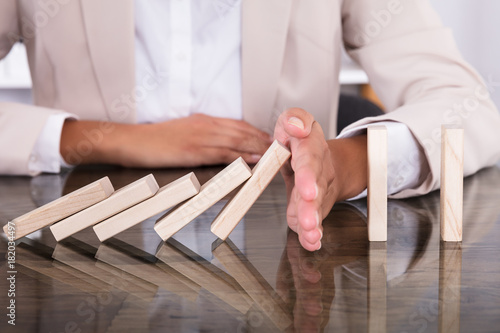 Hand Stopping Wooden Blocks From Falling