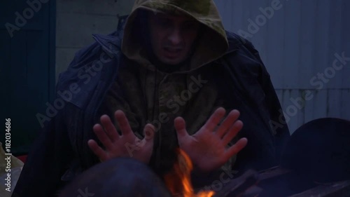 Homeless in front of a fire, close up