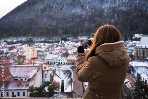 gril taking a photo of an old city