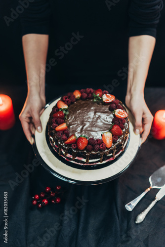 woman putting cake stand on table