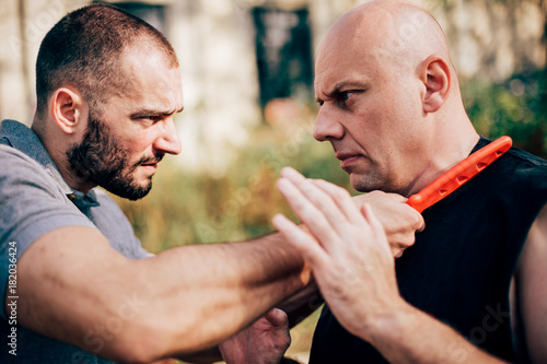 Knife threat. Kapap instructor demonstrates self defense knife threat disarming