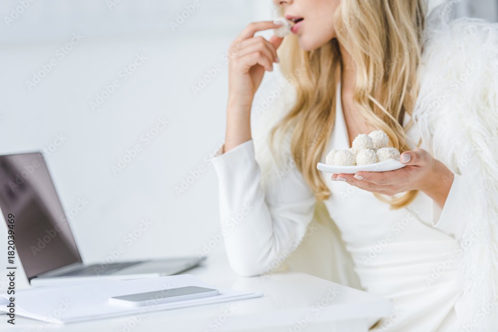 businesswoman with laptop and candies businesswoman with laptop and candies