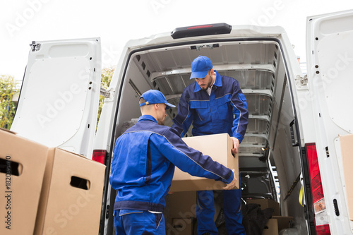 Two Movers Carrying Cardboard Box