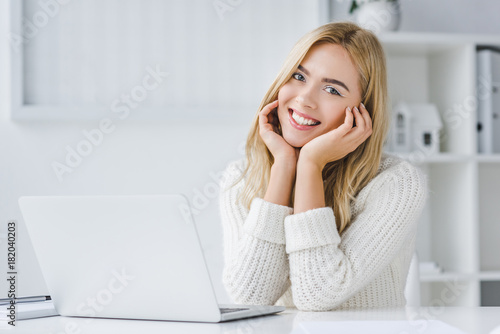 smiling businesswoman with laptop © LIGHTFIELD STUDIOS