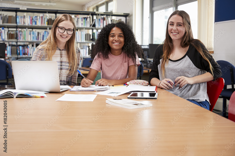 Portrait Of Female College Students Working In Library Together Portrait Of Female College Students Working In Library Together