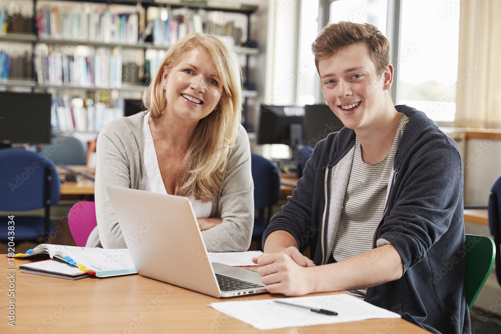 College Student Has Individual Tuition From Teacher In Library College Student Has Individual Tuition From Teacher In Library