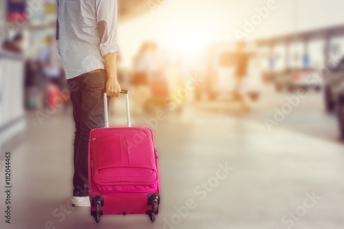 Close-up of young man traveler with baggage suitcases at international airport, travel concept.