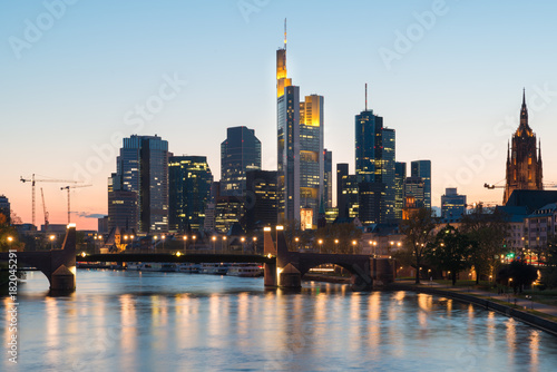 View of Frankfurt am Main skyline at dusk along Main river with cruise ship in Frankfurt  Germany