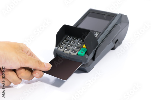 hands insert blank black credit card into card machine isolated on white background