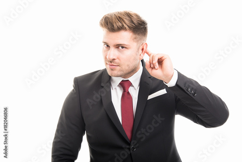 Handsome business man showing not hearing gesture