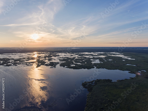 Aerial view over Zuvintas shallow lake Nature Reserve in Lithuania. During late summer evening. © Mantas Bac