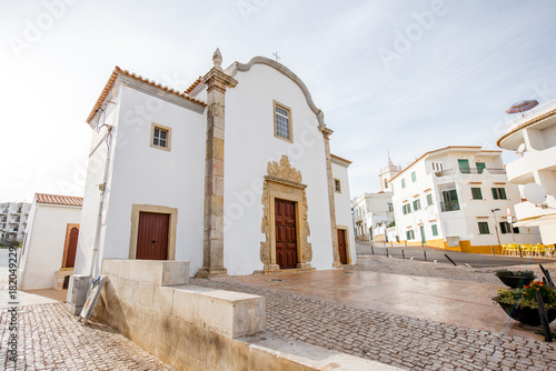 Cityscape view on the old town with beautiful white houses and church in Albufeira city on the south of Portugal photo