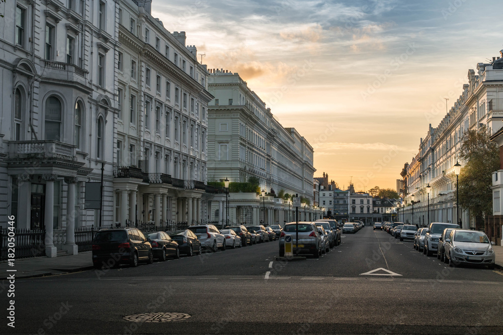 London Chelsea street view white houses with cars at sunset