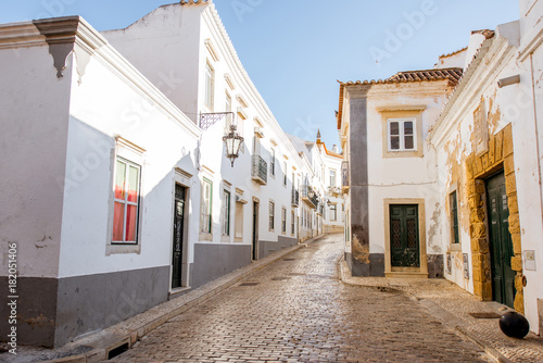Street view with white houses in the old town of Faro on the south of Portugal