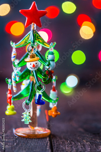 Glass Christmas Tree Toy on Blurred, Sparkling Background, Free Space for text, Christmas Wallpaper, New Year Mood