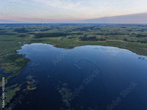 Aerial view over Zuvintas shallow lake Nature Reserve in Lithuania. During late summer evening. photo