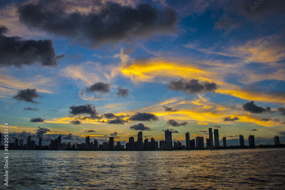 city silhouette, bay at sunset,  orange and stormy clouds, cartagena de indias, Colombia