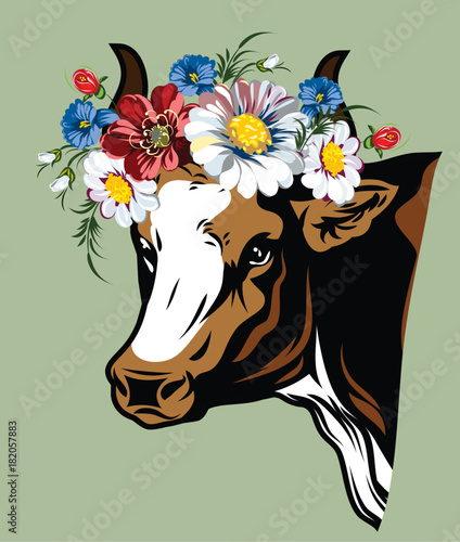 Portrait of a cow in a flower wreath of field flowers
