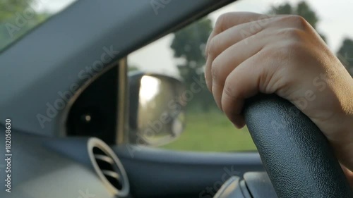 Wallpaper Mural Closeup of female teen driver's hands on steering wheel in evening. Alone person driving in the country in twilight, slowmotion shot. Torontodigital.ca