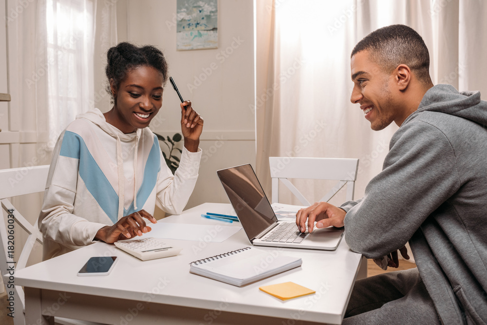 Obraz premium couple using laptop and calculating something